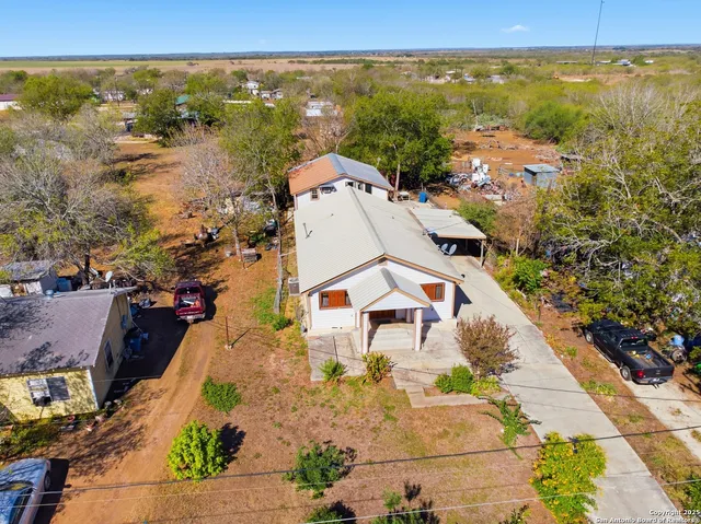 an aerial view of residential houses with outdoor space