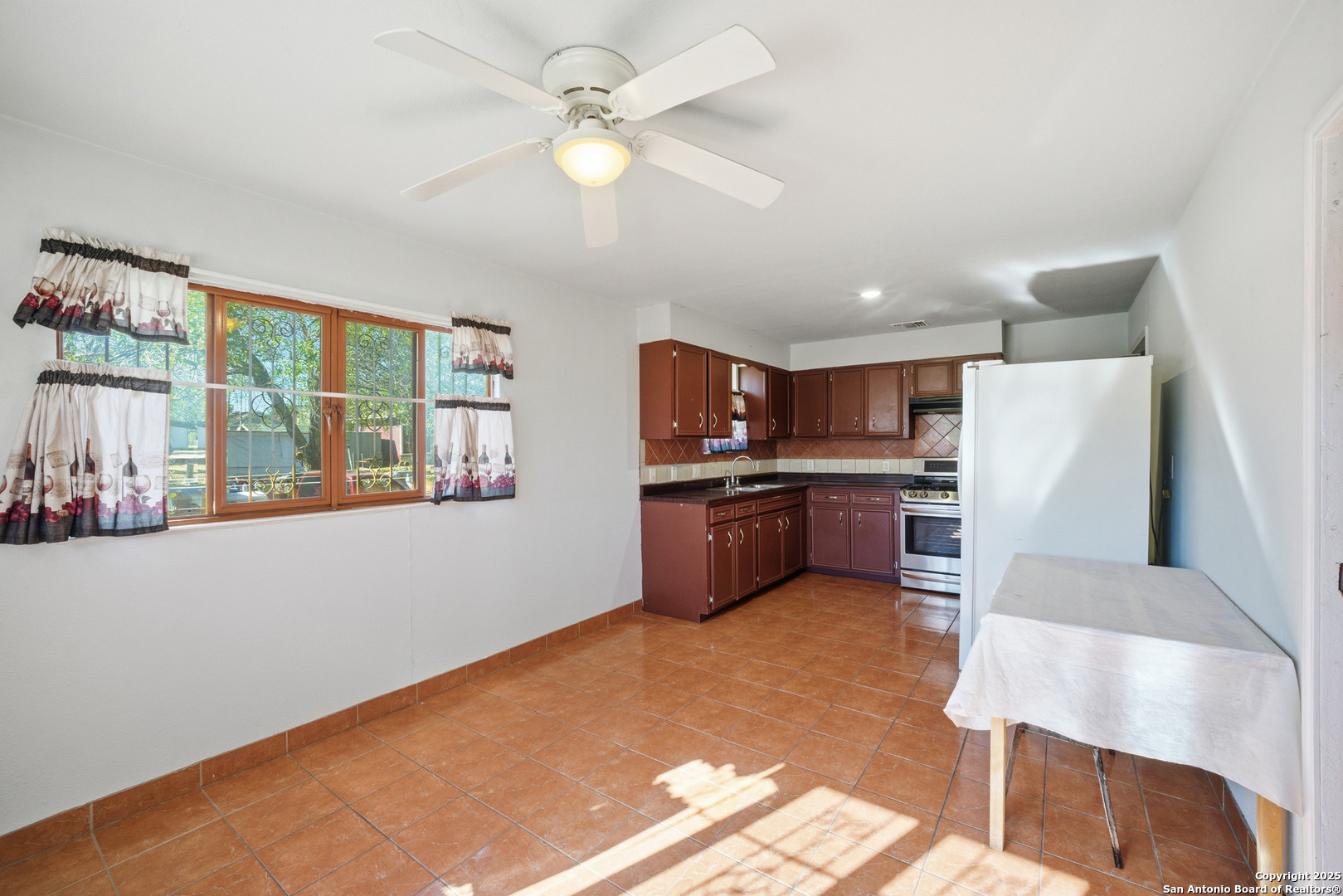406 North Rancho Road Nixon, TX 78140 - Photo 9 of 31 a kitchen with kitchen island a large counter top space a sink stainless steel appliances and cabinets