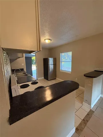 a kitchen with a stove and a refrigerator
