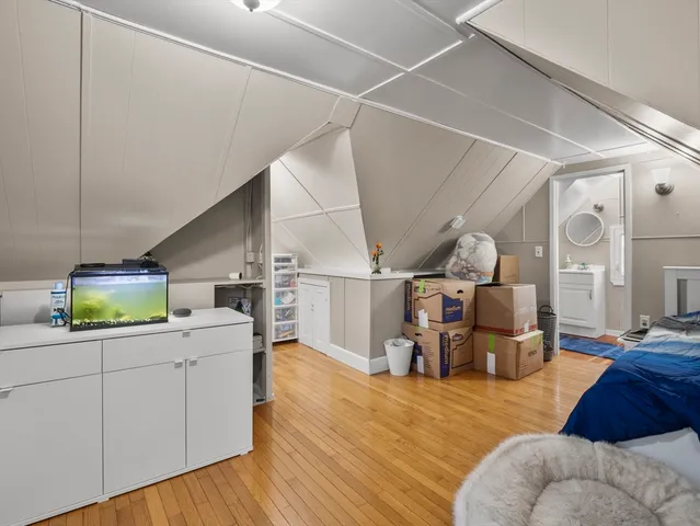 a kitchen with a sink cabinets and wooden floor