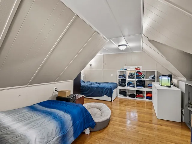 a bedroom with furniture and a wooden floor