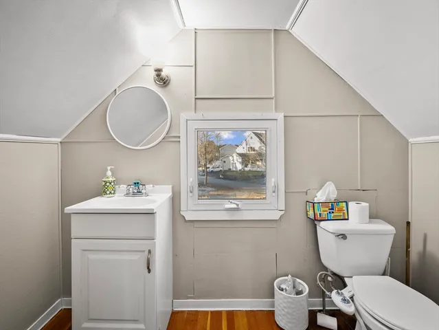 a bathroom with a toilet a sink and a mirror