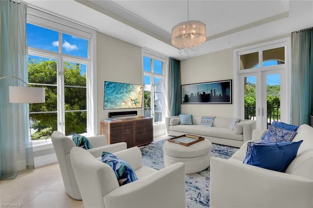 a living room with furniture large window and flat screen tv