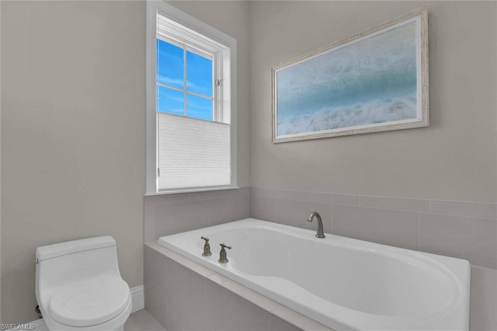 684 10th Avenue South, Unit D1 Naples, FL 34102 - Photo 25 of 45 a white bath tub sitting next to a toilet