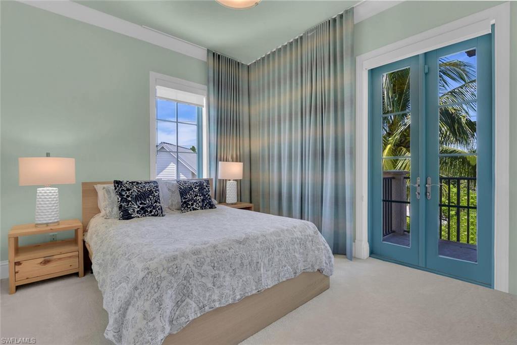 684 10th Avenue South, Unit D1 Naples, FL 34102 - Photo 26 of 45 a bedroom with a bed and a window