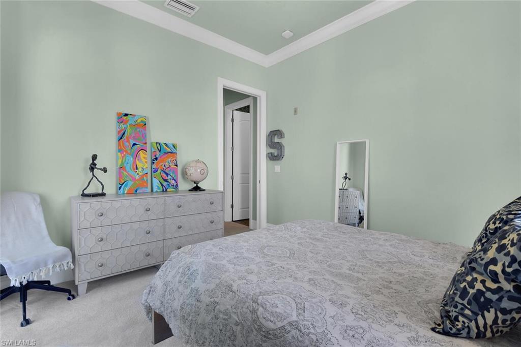 684 10th Avenue South, Unit D1 Naples, FL 34102 - Photo 27 of 45 a bedroom with a bed and furniture