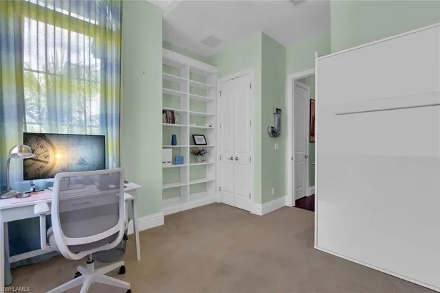 a room with a chair and a lamp on the table