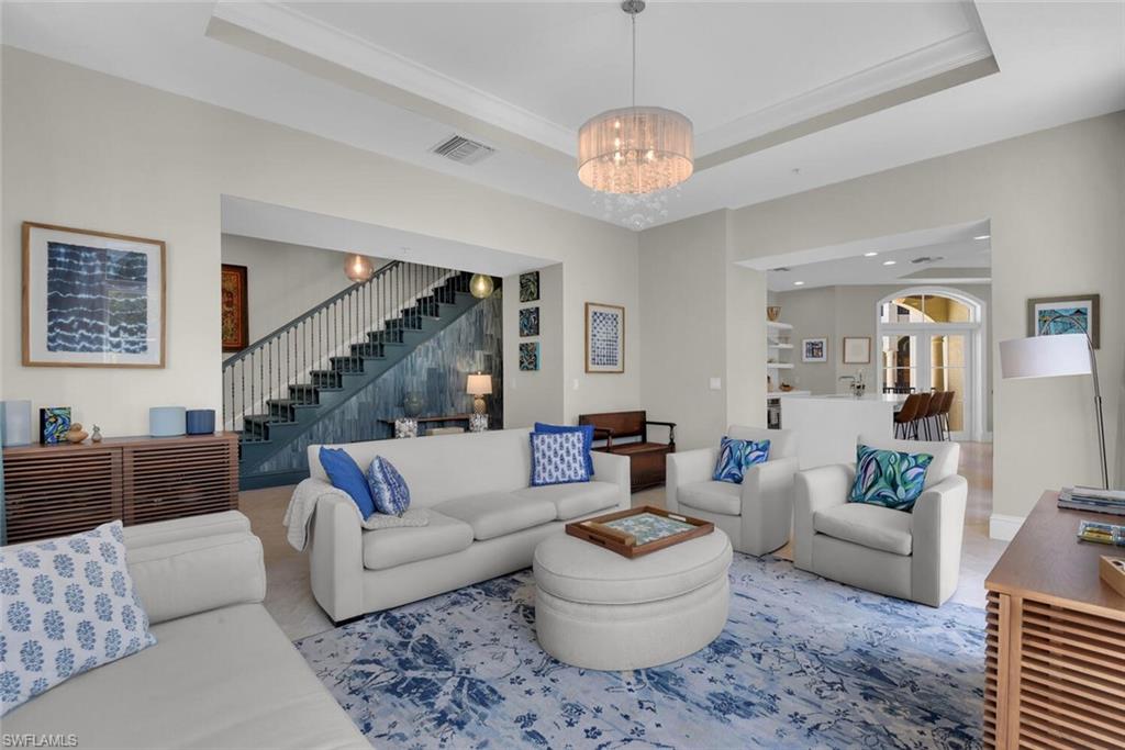 684 10th Avenue South, Unit D1 Naples, FL 34102 - Photo 3 of 45 a living room with furniture and a chandelier