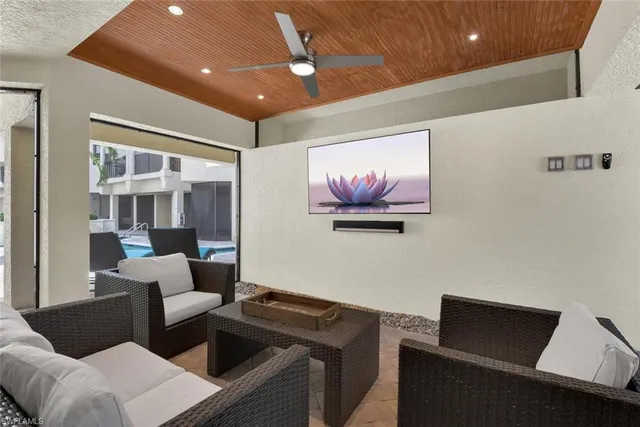 a living room with furniture and a ceiling fan