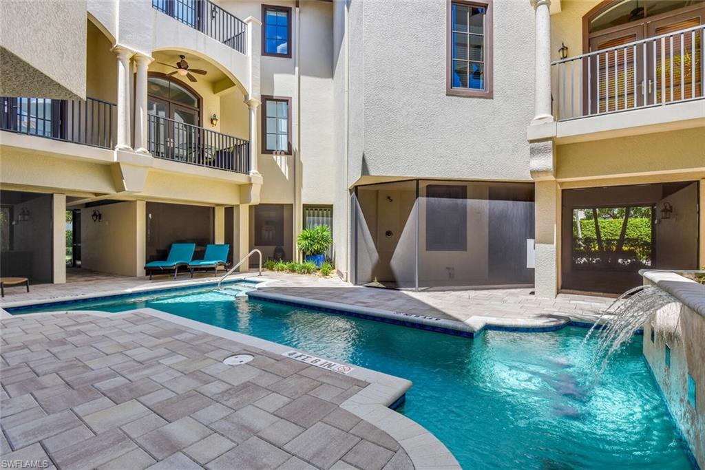 684 10th Avenue South, Unit D1 Naples, FL 34102 - Photo 40 of 45 a view of pool with lawn chairs and floor to ceiling window
