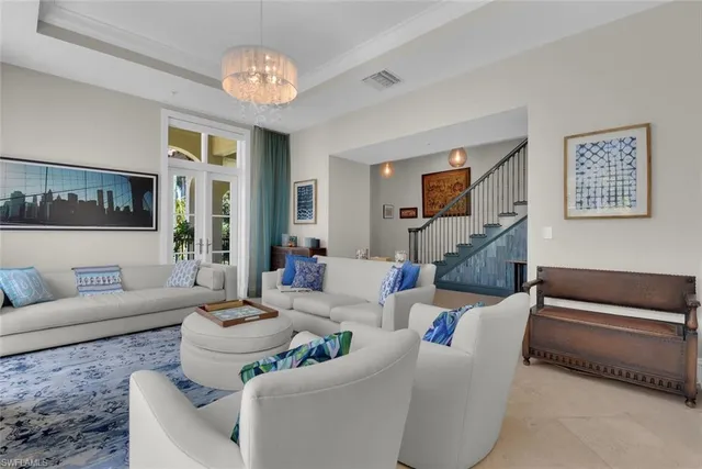 a living room with furniture and a chandelier
