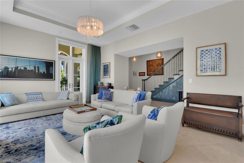 684 10th Avenue South, Unit D1 Naples, FL 34102 - Photo 4 of 45 a living room with furniture and a chandelier