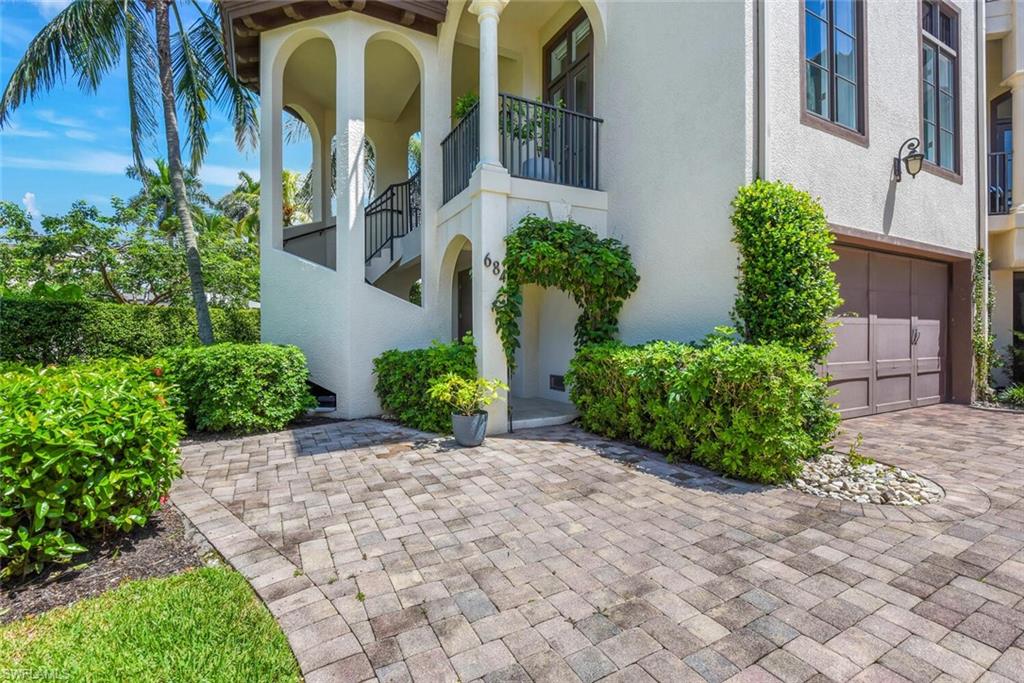 684 10th Avenue South, Unit D1 Naples, FL 34102 - Photo 41 of 45 a front view of yellow house with a yard