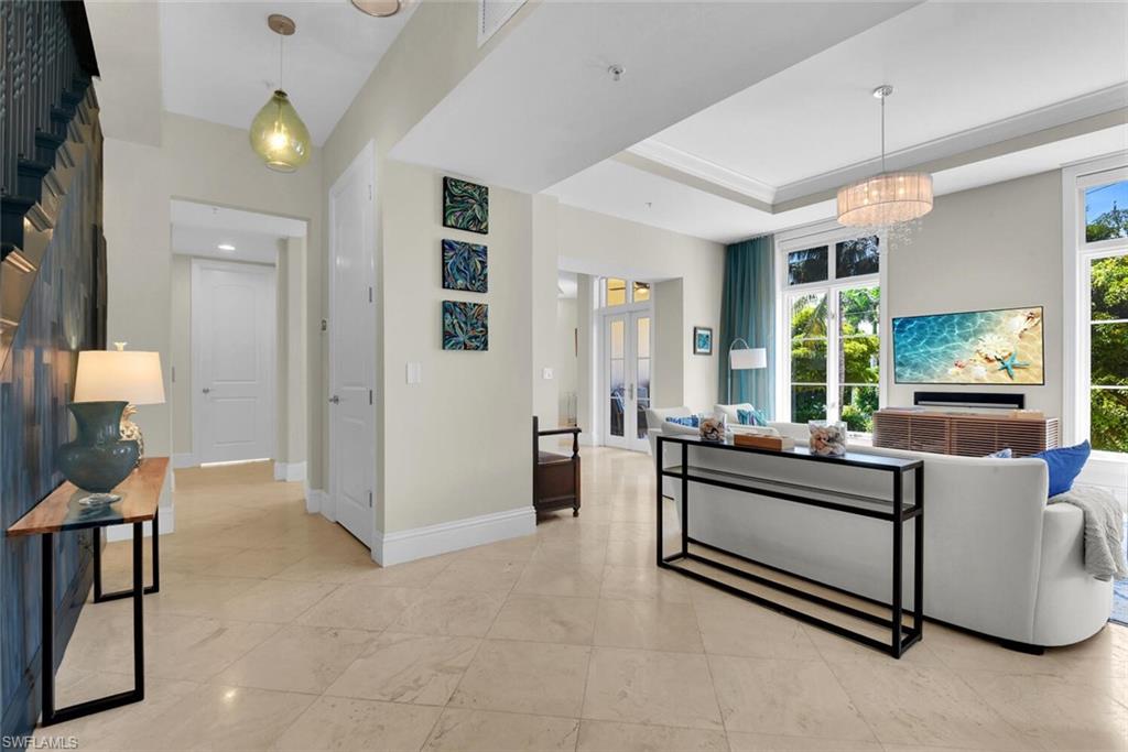 684 10th Avenue South, Unit D1 Naples, FL 34102 - Photo 5 of 45 a living room with furniture and a table