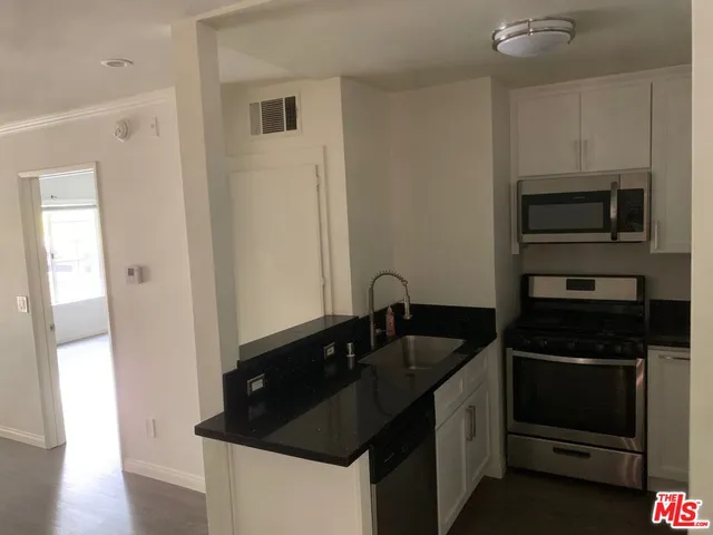 a kitchen with a sink and a refrigerator