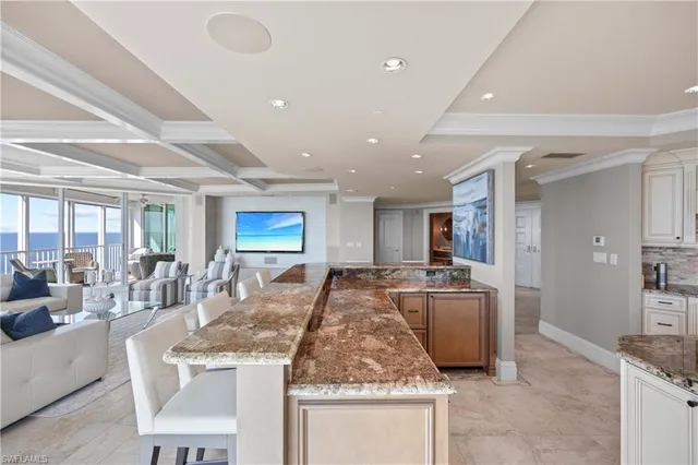 a spacious bedroom with a bed and a chandelier