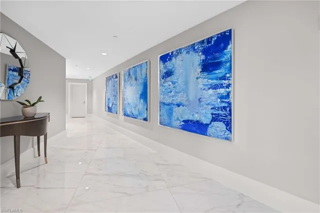 a view of a hallway with paintings on the wall