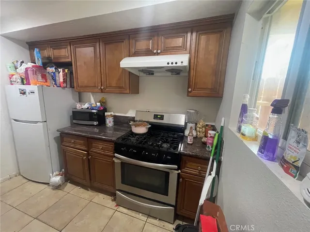 a kitchen with stainless steel appliances granite countertop a stove and a refrigerator