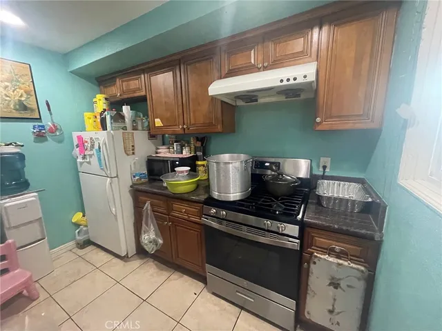 a kitchen with a stove and a refrigerator