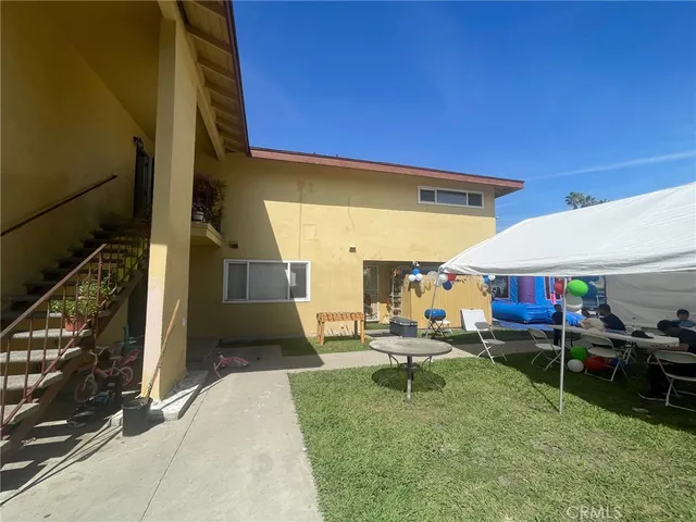 a backyard of a house with outdoor seating
