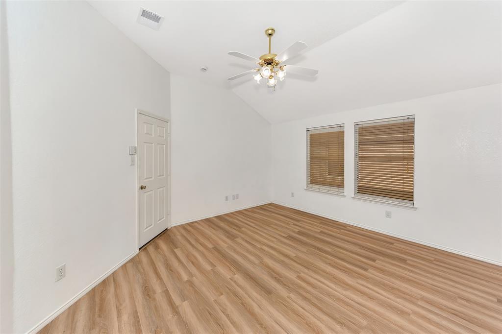 1006 Buckingham Drive Forney, TX 75126 - Photo 11 of 31 a view of an empty room with wooden floor and a window