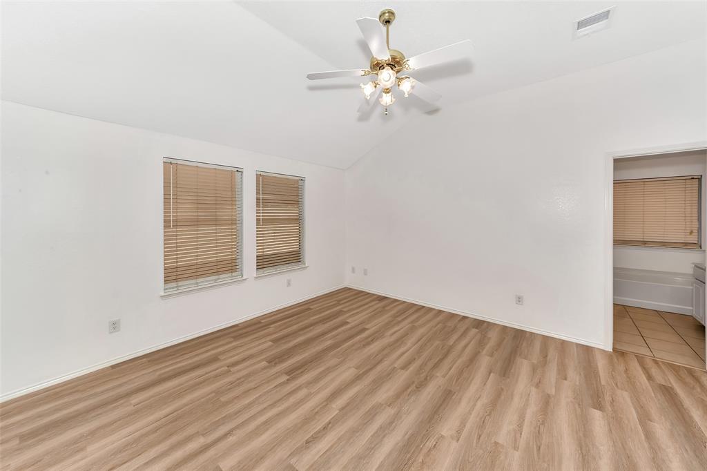 1006 Buckingham Drive Forney, TX 75126 - Photo 12 of 31 wooden floor in an empty room with a window