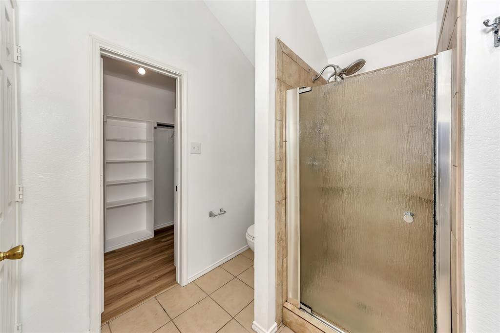 1006 Buckingham Drive Forney, TX 75126 - Photo 14 of 31 a bathroom with a shower and a glass door