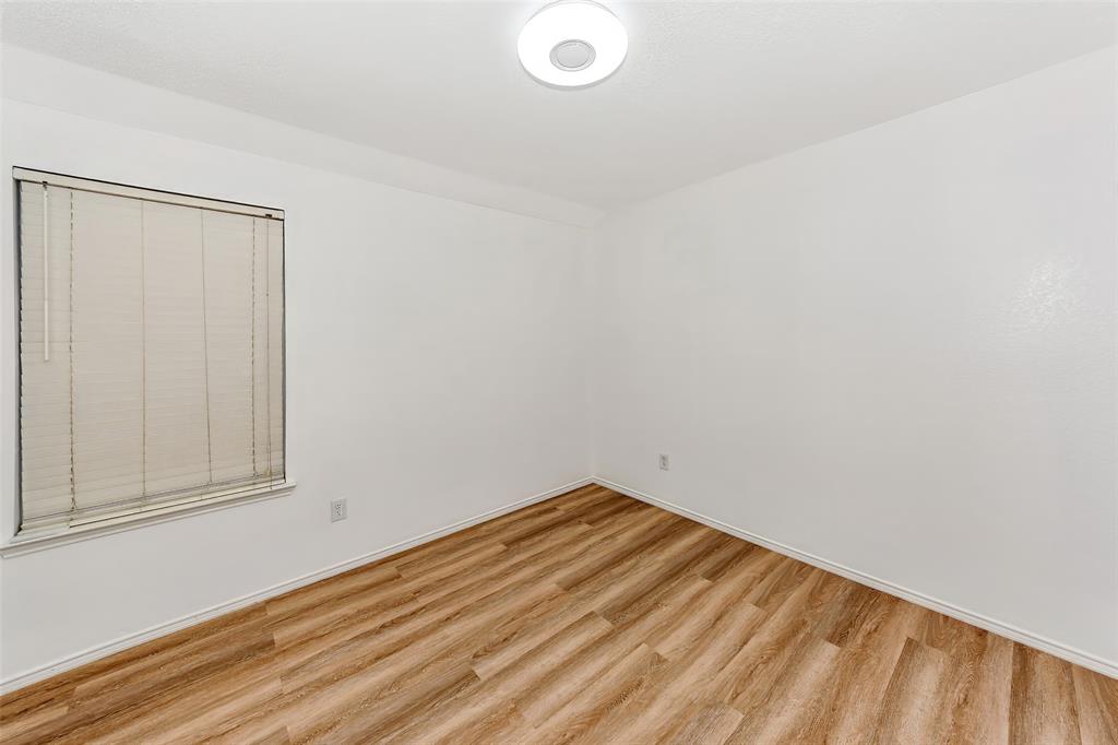 1006 Buckingham Drive Forney, TX 75126 - Photo 17 of 31 a view of a room with wooden floor and white walls