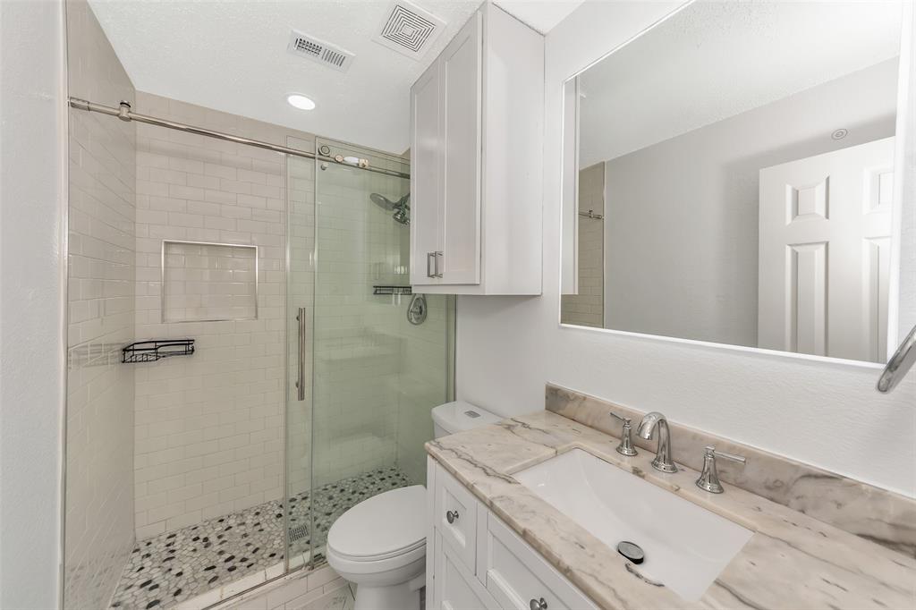 1006 Buckingham Drive Forney, TX 75126 - Photo 19 of 31 a bathroom with a sink a toilet and shower