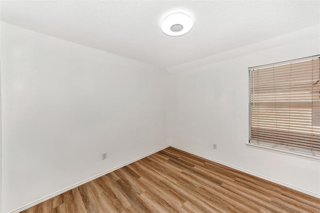 1006 Buckingham Drive Forney, TX 75126 - Photo 22 of 31 a view of a room with wooden floor and fan