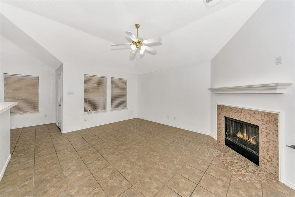 1006 Buckingham Drive Forney, TX 75126 - Photo 5 of 31 a view of an empty room with chandelier fan and fire place