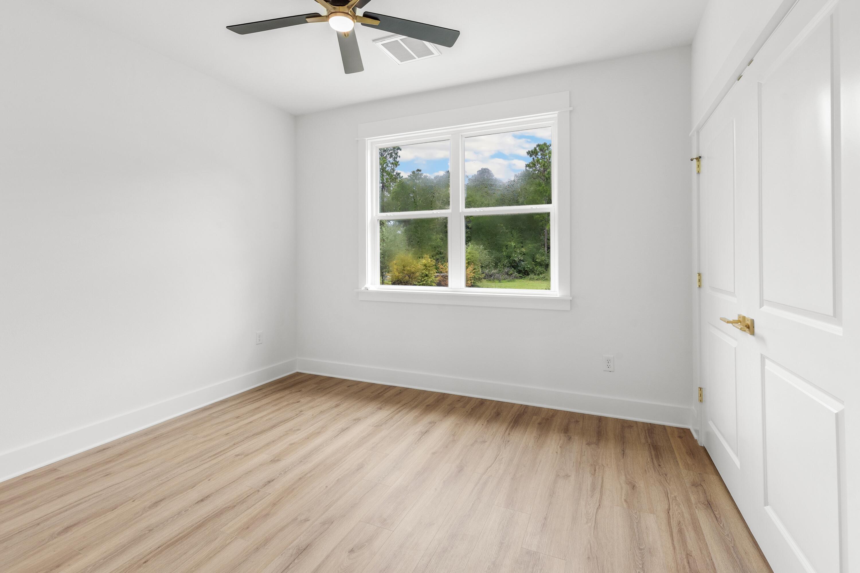 160 Clarke Hl Road Freeport, FL 32439 - Photo 11 of 34 an empty room with a window and a ceiling fan