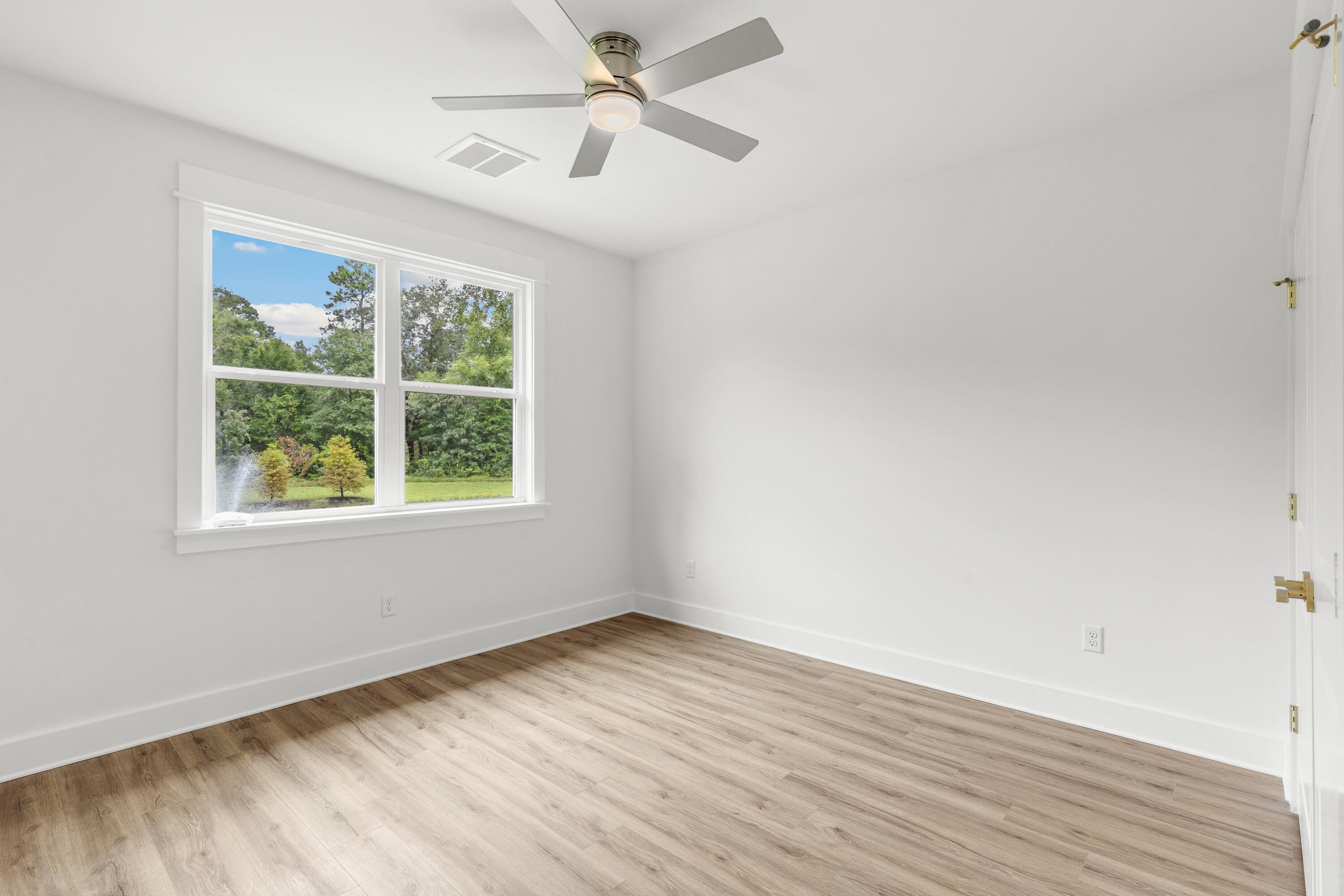 160 Clarke Hl Road Freeport, FL 32439 - Photo 13 of 34 wooden floor in an empty room with a window
