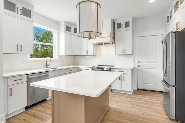 a kitchen with a refrigerator a sink and a stove
