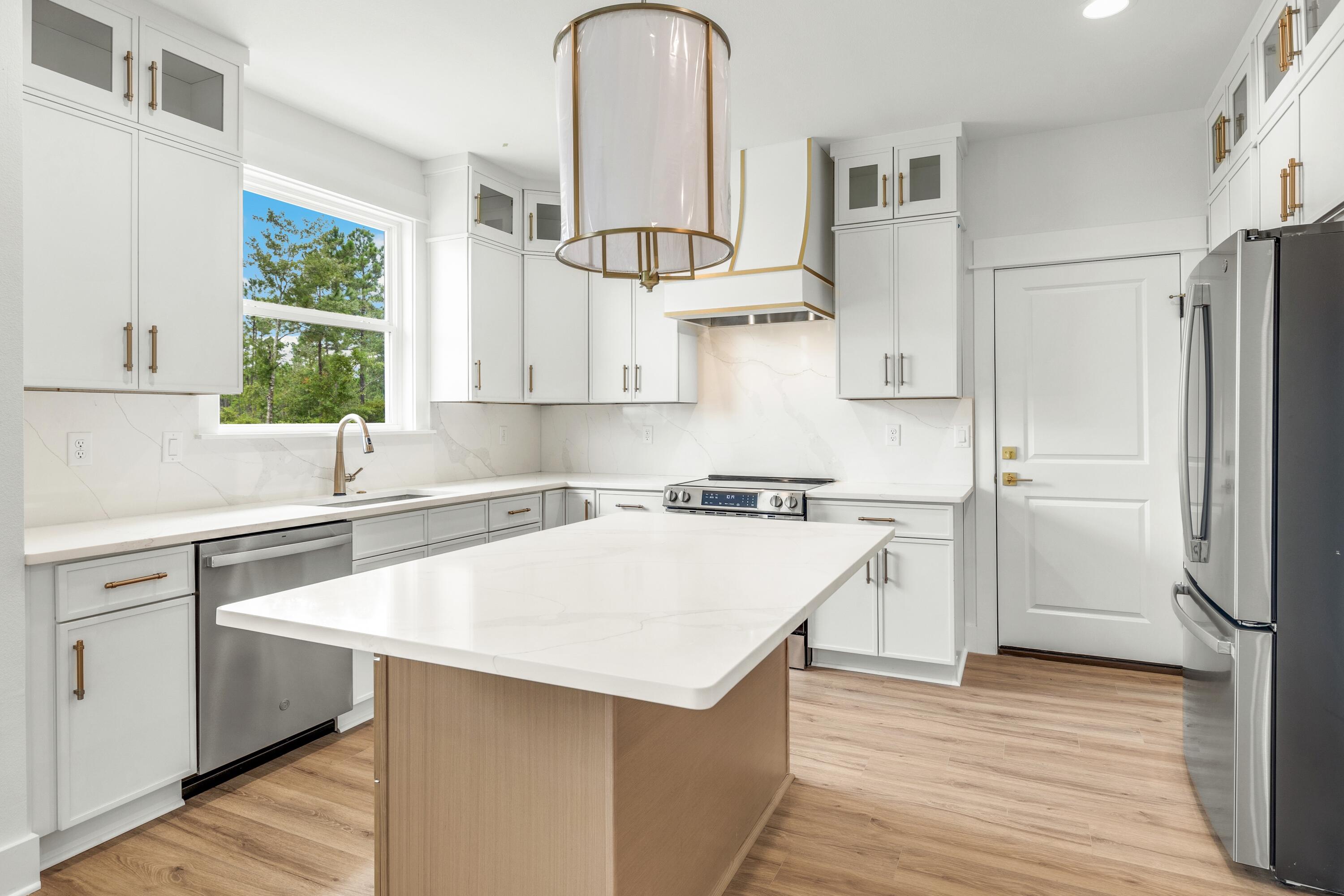 160 Clarke Hl Road Freeport, FL 32439 - Photo 2 of 34 a kitchen with a refrigerator a sink and a stove