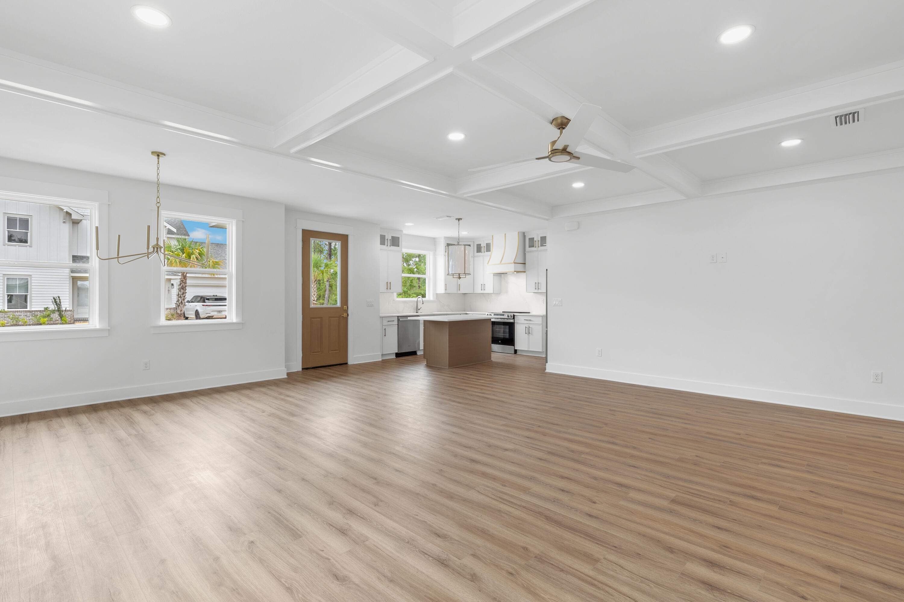 160 Clarke Hl Road Freeport, FL 32439 - Photo 4 of 34 an empty room with wooden floor chandelier and windows