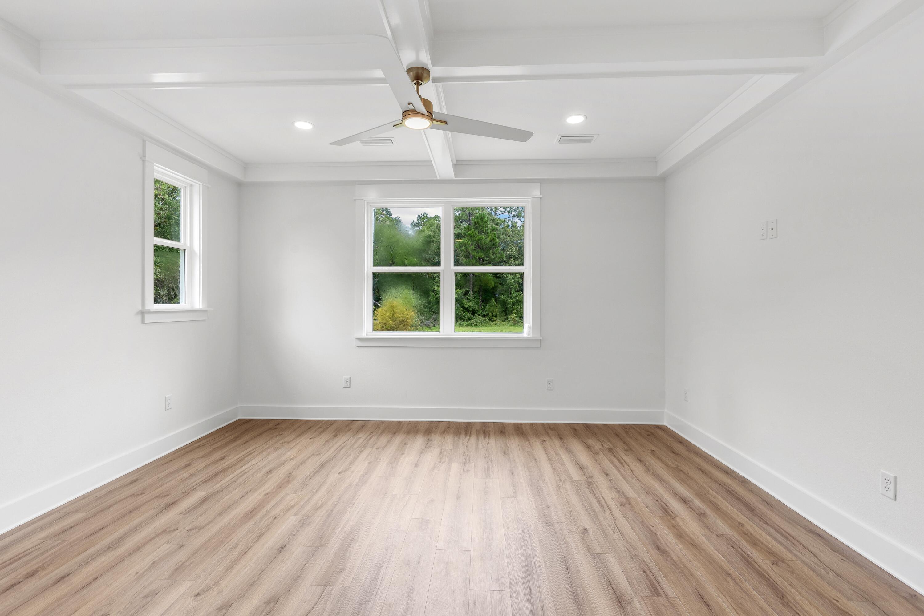 160 Clarke Hl Road Freeport, FL 32439 - Photo 9 of 34 an empty room with wooden floor and windows