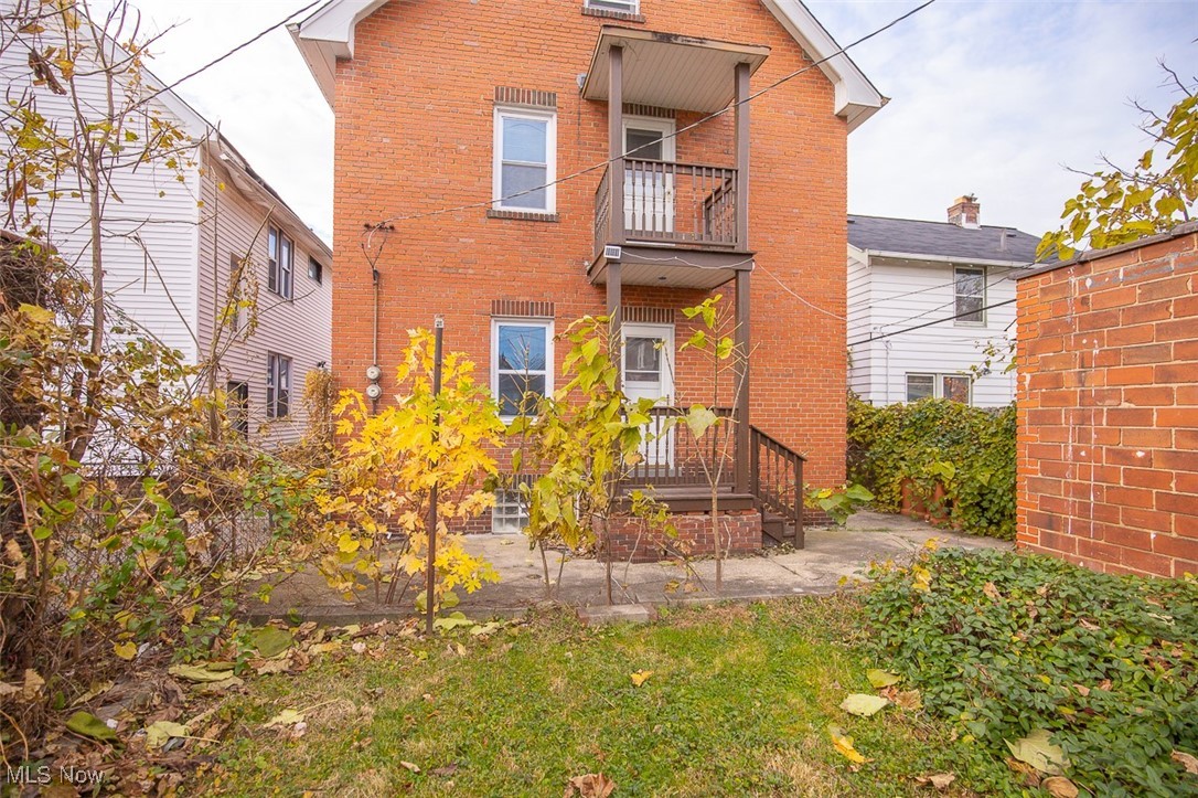 951 Royal Road Cleveland, OH 44110 - Photo 27 of 28 Rear view of house featuring brick siding, a patio, and a balcony
