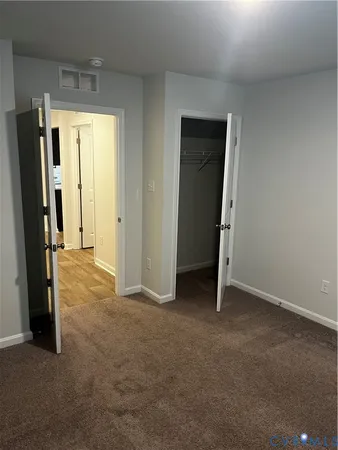a view of an empty room with a fireplace