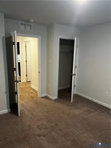 an empty room with closet and a fireplace