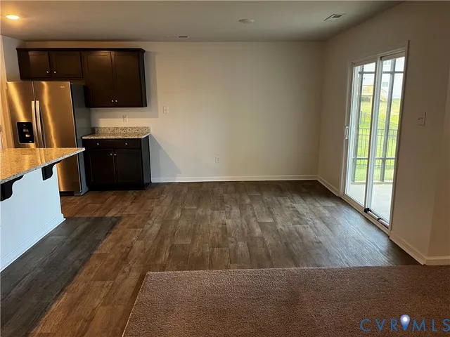 a view of kitchen with wooden floor and electronic appliances