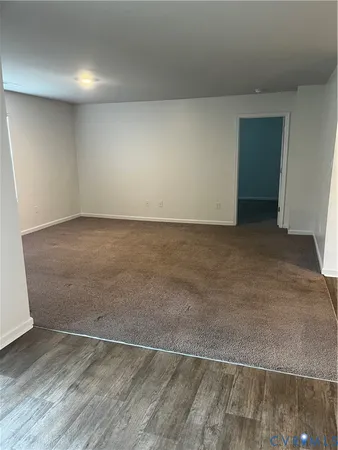 an empty room with wooden floor
