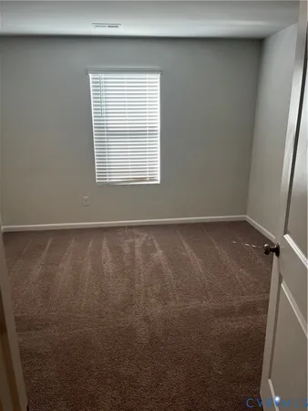 a view of a small space with wooden floor and a window
