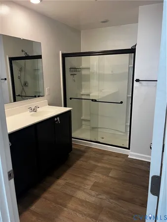 a room with a wooden floor and mirror