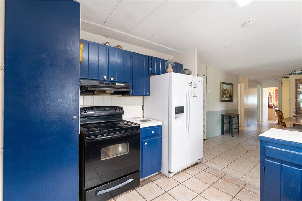 1877 C 478A Webster, FL 33597 - Photo 21 of 65 a kitchen with stainless steel appliances a stove a refrigerator and cabinets
