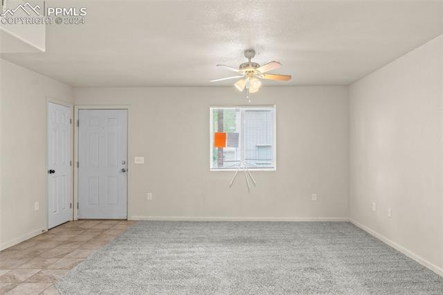 6010 Oak Street Rye, CO 81069 - Photo 14 of 29 Empty room featuring light tile flooring and ceiling fan