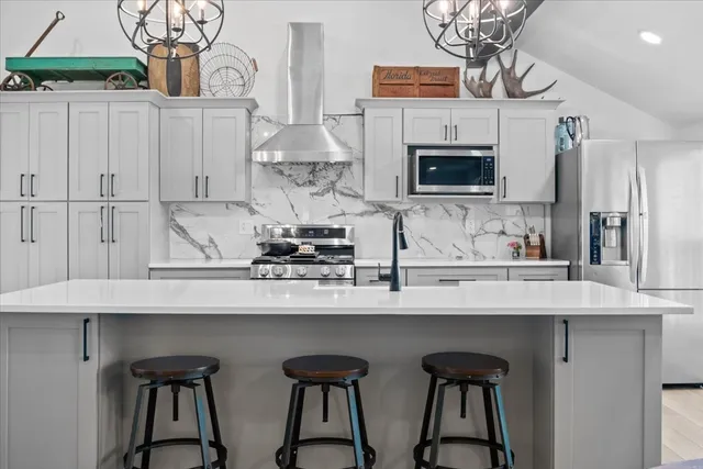 a kitchen with stainless steel appliances a sink and cabinets