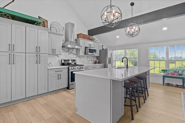 a kitchen with cabinets and stainless steel appliances