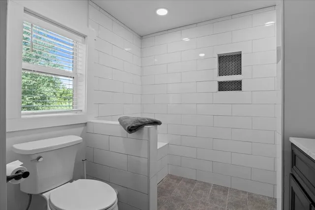 a white toilet sitting next to a bathroom sink