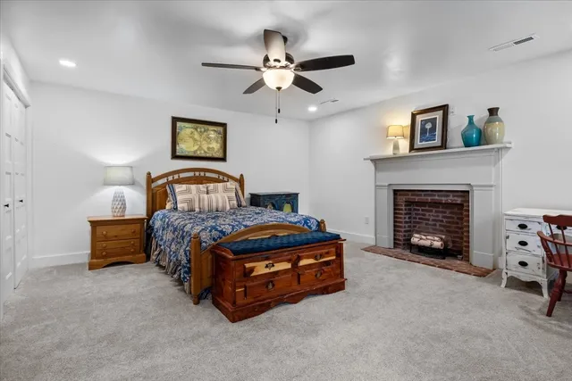 a bedroom with a bed and a fireplace